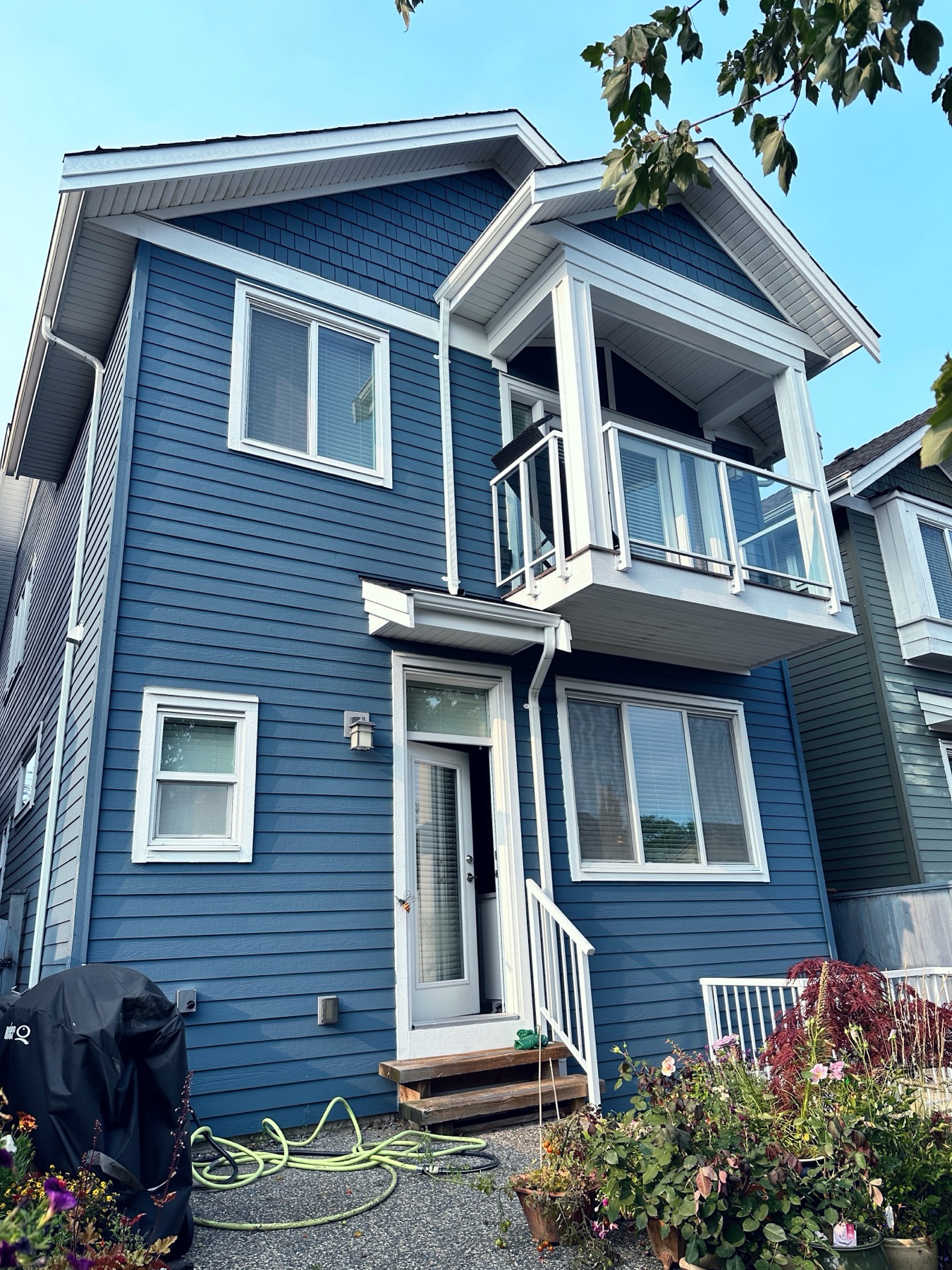 A two storey home painted slate blue